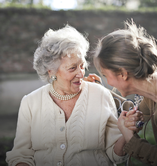 A woman converses with an older woman, discussing topics related to neuropsychology.