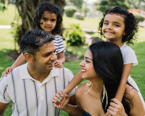 Father with two young daughters sharing a happy moment outdoors