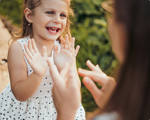 A woman and a little girl share a joyful moment